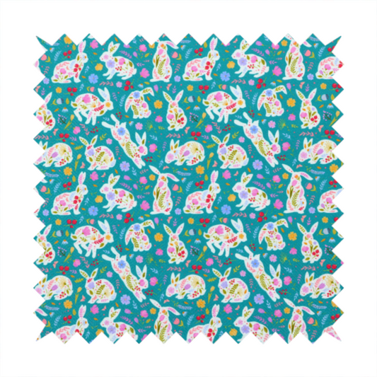 This fabric features a vibrant, folk-art inspired Easter pattern set against a rich teal-green background. The design is characterized by its high-contrast colour palette and intricate floral silhouettes.