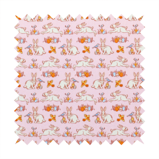 This fabric features a vintage-style Easter meadow pattern on a soft, blush-pink background. The design is reminiscent of classic children’s book illustrations, using fine, orange-brown linework and a muted pastel palette.