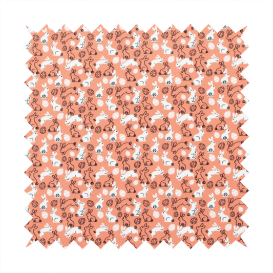 This fabric features a graphic, contemporary Easter pattern set against a warm, terracotta-orange background. The design is characterized by its clean, high-contrast motifs and a limited, modern colour palette.