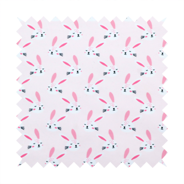 This fabric features a modern, minimalist bunny pattern set against a soft, pale pink background. The design is clean and contemporary, focusing on a repeating motif of stylized rabbit faces.