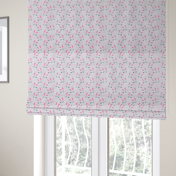 The fabric used to create these Roman blinds features a modern, minimalist bunny pattern set against a soft, pale pink background. The design is clean and contemporary, focusing on a repeating motif of stylized rabbit faces.