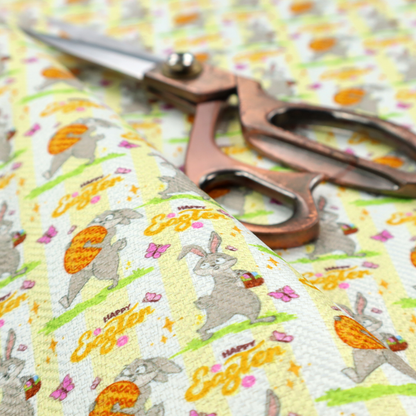 This fabric features a cheery and active Easter bunny pattern set against a vertical striped background of pale yellow and white. The design has a classic animated feel, full of personality and holiday spirit.