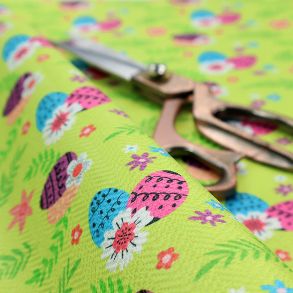 This fabric features a vibrant and modern Easter floral pattern set against a bright lime-green background. The design has a high-energy, "pop-art" feel with bold colours and playful, hand-drawn textures.