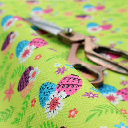This fabric features a vibrant and modern Easter floral pattern set against a bright lime-green background. The design has a high-energy, "pop-art" feel with bold colours and playful, hand-drawn textures.