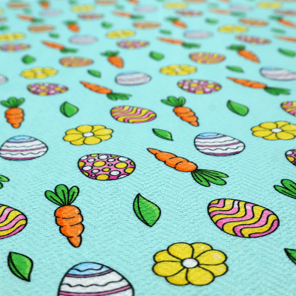 This fabric features a bright and cheerful Easter garden pattern set against a refreshing sky-blue background. The design is clean and energetic, using a cartoon-style illustration technique with bold black outlines.