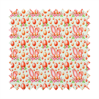 This fabric features a warm, watercolour-style Easter pattern on a very pale mint-green background. The design is rich in texture and soft tones, giving it a cosy and traditional holiday feel.