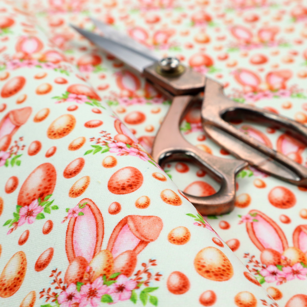 This fabric features a warm, watercolour-style Easter pattern on a very pale mint-green background. The design is rich in texture and soft tones, giving it a cosy and traditional holiday feel.