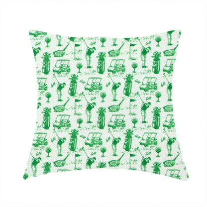 The fabric used to create these handmade cushions is a repeating novelty fabric pattern featuring green hand-sketched illustrations of golfers, golf bags, golf carts, and flags on a light cream-colored background.