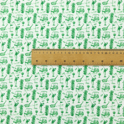 A repeating novelty fabric pattern featuring green hand-sketched illustrations of golfers, golf bags, golf carts, and flags on a light cream-colored background.