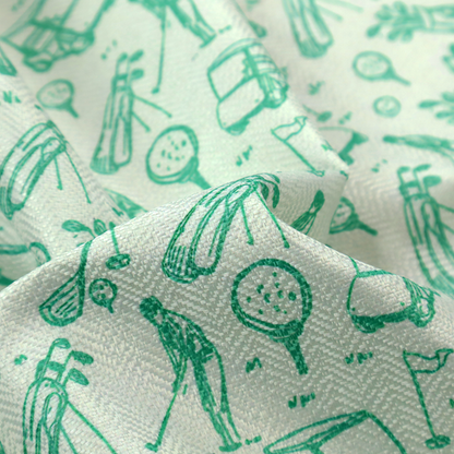 A repeating fabric pattern featuring hand-sketched green illustrations of golf carts, golfers, golf bags, golf balls on tees, and flags on a light mint-green background.