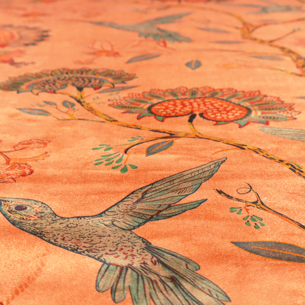 A vibrant botanical fabric pattern featuring detailed hummingbirds in flight among lush tropical flowers.