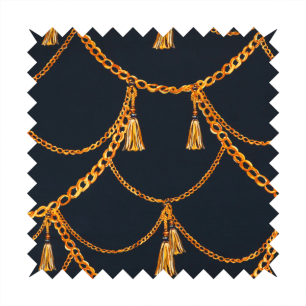 A luxury fashion-inspired fabric on a deep navy-black background. The design features elegant, draped golden chains arranged in a repeating scallop or 'swag' pattern, accented by highly detailed golden silk tassels suspended from ornate beaded cords.