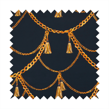 A luxury fashion-inspired fabric on a deep navy-black background. The design features elegant, draped golden chains arranged in a repeating scallop or 'swag' pattern, accented by highly detailed golden silk tassels suspended from ornate beaded cords.