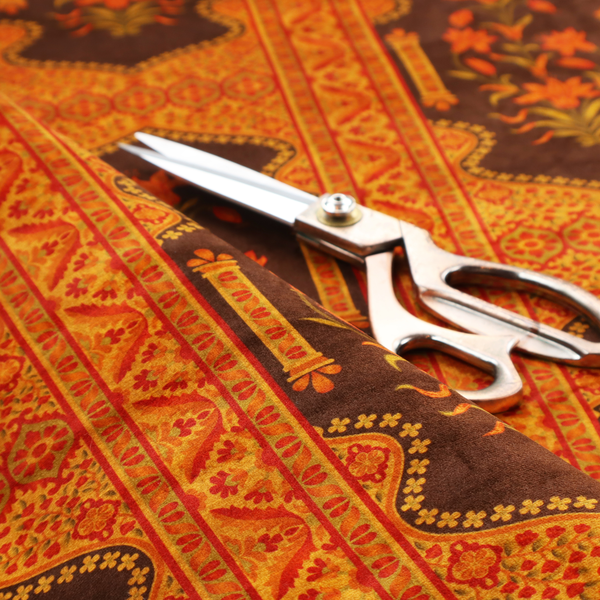 A vertical stripe fabric featuring an intricate Mughal-inspired architectural pattern. The design displays orange lily bouquets enclosed within scalloped 'Palace Gate' arches, separated by decorative geometric borders in saffron, terracotta, and deep chocolate brown.