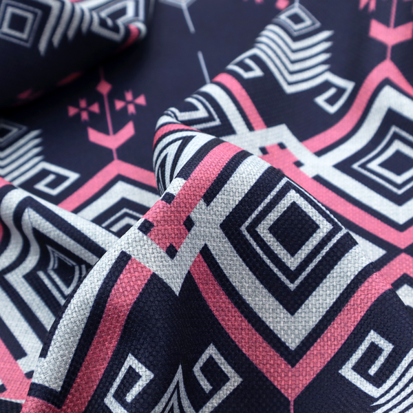 A sharp and sophisticated geometric fabric on a deep midnight navy background. The design features a prominent central horizontal band of interlocking diamonds in crisp white and neon pink, framed by intricate, vertical 'spear-like' motifs and delicate diamond accents that evoke a modern, high-contrast Ikat or tribal-inspired aesthetic.