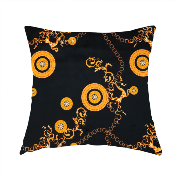 The fabric used to create these handmade cushions is a luxury baroque-style fabric on a black ground featuring a trellis of golden chains interspersed with ornate sun-medallions and amber floral scrolls.