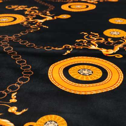 A luxury baroque-style fabric on a black ground featuring a trellis of golden chains interspersed with ornate sun-medallions and amber floral scrolls.
