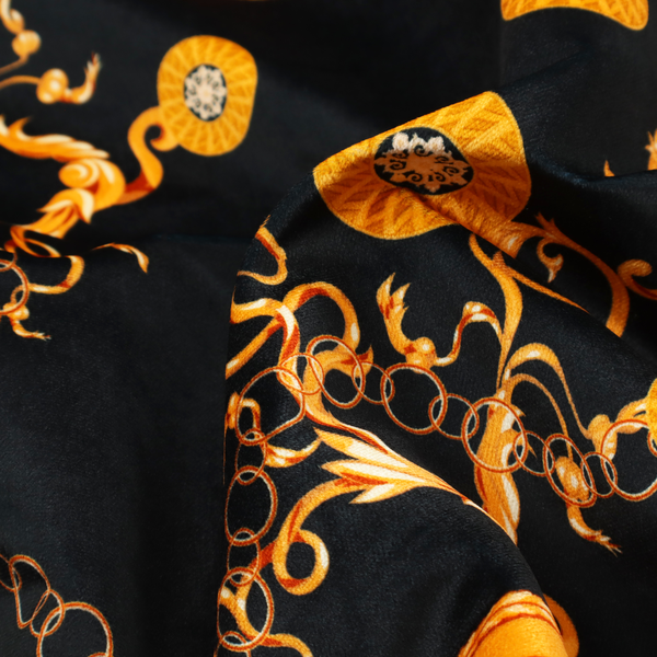 A luxury baroque-style fabric on a black ground featuring a trellis of golden chains interspersed with ornate sun-medallions and amber floral scrolls.