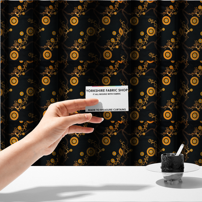 The fabric used to create these made-to-measure curtains is a luxury baroque-style fabric on a black ground featuring a trellis of golden chains interspersed with ornate sun-medallions and amber floral scrolls.