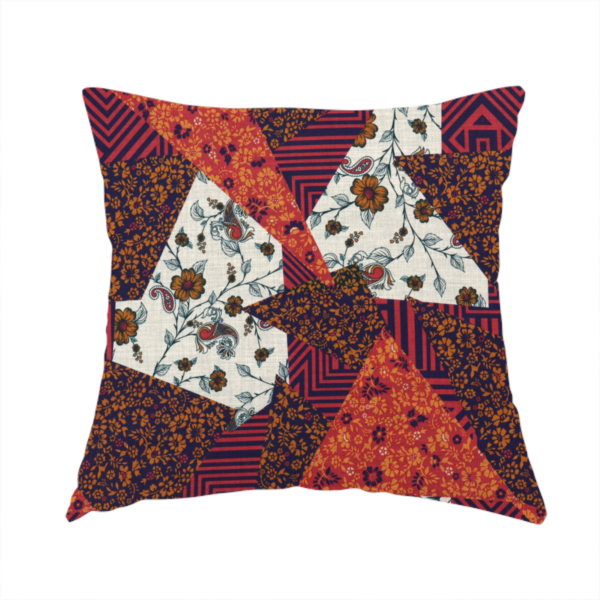 The fabric used to create this handmade cushion is a rich and layered patchwork fabric featuring a collage of sharp, angular shards and geometric fragments. The design blends diverse motifs including vintage-style burnt orange florals, delicate cream botanical vines with paisley accents, and bold navy and terracotta linear chevrons, creating a warm, textured, and maximalist mosaic aesthetic.
