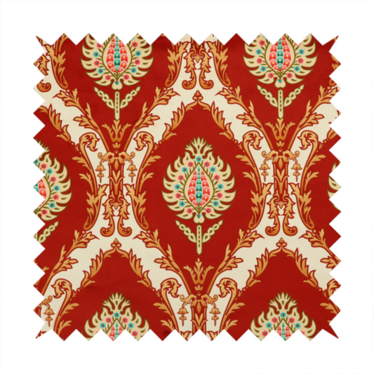 A grand, symmetrical damask-style fabric on a rich crimson red ground featuring ornate cream-colored leaf frames enclosing vibrant, stylized floral pinecones with teal and pink accents.