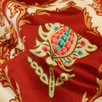 A grand, symmetrical damask-style fabric on a rich crimson red ground featuring ornate cream-colored leaf frames enclosing vibrant, stylized floral pinecones with teal and pink accents.