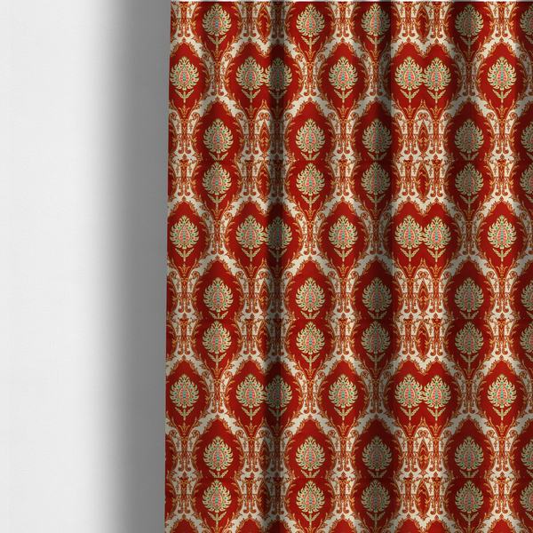 The fabric used to create these made-to-measure curtains is a grand, symmetrical damask-style fabric on a rich crimson red ground featuring ornate cream-colored leaf frames enclosing vibrant, stylized floral pinecones with teal and pink accents.