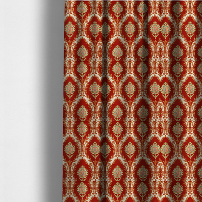 The fabric used to create these made-to-measure curtains is a grand, symmetrical damask-style fabric on a rich crimson red ground featuring ornate cream-colored leaf frames enclosing vibrant, stylized floral pinecones with teal and pink accents.