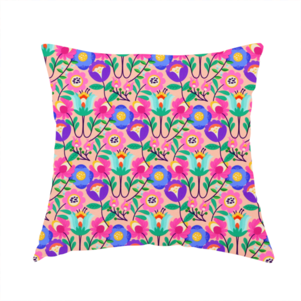 The fabric used to create this handmade cushion is a vibrant and energetic floral fabric on a soft peach-blush background. The design features a symmetrical folk-art arrangement of stylized flowers in neon pink, electric blue, violet, and turquoise, connected by emerald green leaves and delicate black stems in a dense, mirrored repeat.
