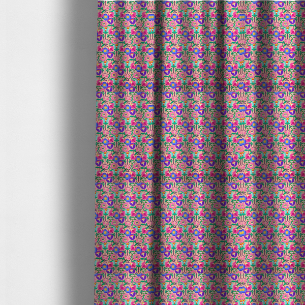 The fabric used to create these made-to-measure curtains is a vibrant and energetic floral fabric on a soft peach-blush background. The design features a symmetrical folk-art arrangement of stylized flowers in neon pink, electric blue, violet, and turquoise, connected by emerald green leaves and delicate black stems in a dense, mirrored repeat.