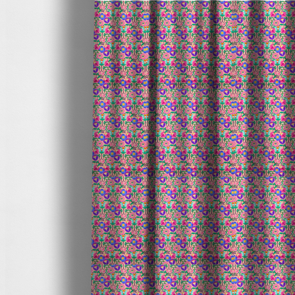 The fabric used to create these made-to-measure curtains is a vibrant and energetic floral fabric on a soft peach-blush background. The design features a symmetrical folk-art arrangement of stylized flowers in neon pink, electric blue, violet, and turquoise, connected by emerald green leaves and delicate black stems in a dense, mirrored repeat.