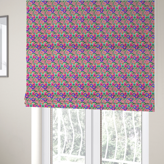 The fabric used to create these Roman blinds is a vibrant and energetic floral fabric on a soft peach-blush background. The design features a symmetrical folk-art arrangement of stylized flowers in neon pink, electric blue, violet, and turquoise, connected by emerald green leaves and delicate black stems in a dense, mirrored repeat.