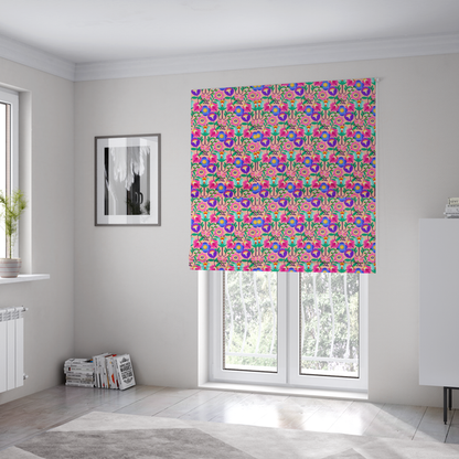 The fabric used to create these Roman blinds is a vibrant and energetic floral fabric on a soft peach-blush background. The design features a symmetrical folk-art arrangement of stylized flowers in neon pink, electric blue, violet, and turquoise, connected by emerald green leaves and delicate black stems in a dense, mirrored repeat.