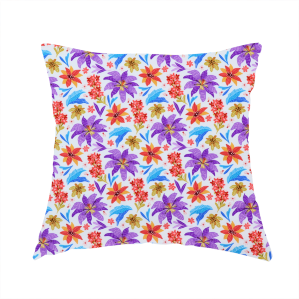 The fabric used to create this handmade cushion is a bright and airy botanical fabric on a clean white background. The design features a scattered, high-saturation mix of large violet lilies, fiery orange-red poinsettias, and electric blue palm-like fronds, accented by delicate pink blossoms and olive green foliage in a lively, contemporary tropical repeat.
