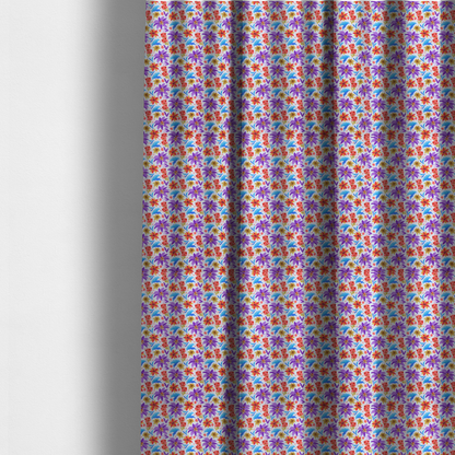 The fabric used to create these made-to-measure curtains is a bright and airy botanical fabric on a clean white background. The design features a scattered, high-saturation mix of large violet lilies, fiery orange-red poinsettias, and electric blue palm-like fronds, accented by delicate pink blossoms and olive green foliage in a lively, contemporary tropical repeat.
