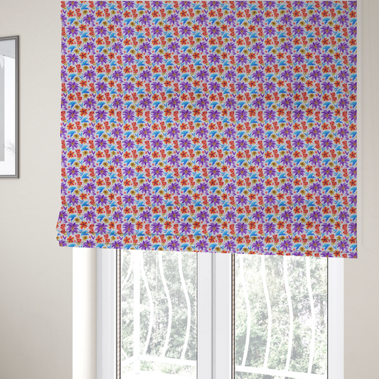 The fabric used to create these Roman blinds is a bright and airy botanical fabric on a clean white background. The design features a scattered, high-saturation mix of large violet lilies, fiery orange-red poinsettias, and electric blue palm-like fronds, accented by delicate pink blossoms and olive green foliage in a lively, contemporary tropical repeat.
