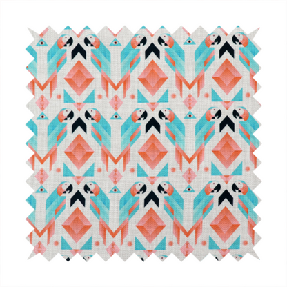 A modern and vibrant geometric fabric on a textured, off-white linen-look background. The design features a symmetrical repeat of abstract parrots rendered in sharp, angular 'prism' shapes of turquoise, coral-pink, and charcoal black. Interspersed between the birds are large coral diamonds and teal triangles, creating a balanced, contemporary tribal-pop aesthetic.