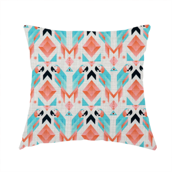 The fabric used to create this handmade cushion is a modern and vibrant geometric fabric on a textured, off-white linen-look background. The design features a symmetrical repeat of abstract parrots rendered in sharp, angular 'prism' shapes of turquoise, coral-pink, and charcoal black. Interspersed between the birds are large coral diamonds and teal triangles, creating a balanced, contemporary tribal-pop aesthetic.