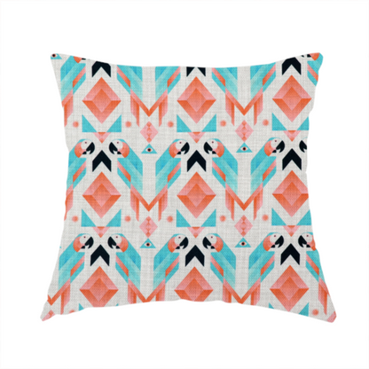 The fabric used to create this handmade cushion is a modern and vibrant geometric fabric on a textured, off-white linen-look background. The design features a symmetrical repeat of abstract parrots rendered in sharp, angular 'prism' shapes of turquoise, coral-pink, and charcoal black. Interspersed between the birds are large coral diamonds and teal triangles, creating a balanced, contemporary tribal-pop aesthetic.