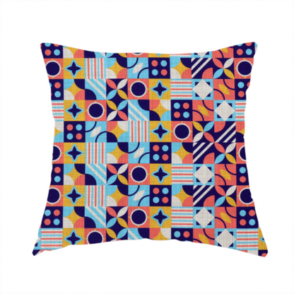 The fabric used to create this handmade cushion is a high-energy, multi-coloured geometric fabric featuring a rhythmic grid of Bauhaus-inspired motifs. The design is a playful mosaic of circles, stars, stripes, and quarter-moons in a vibrant palette of mustard yellow, coral pink, sky blue, and deep midnight navy, all set against a textured, off-white linen-look background.