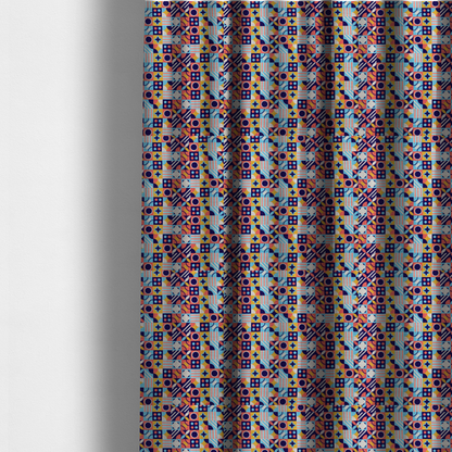 The fabric used to create these made-to-measure curtains is a high-energy, multi-coloured geometric fabric featuring a rhythmic grid of Bauhaus-inspired motifs. The design is a playful mosaic of circles, stars, stripes, and quarter-moons in a vibrant palette of mustard yellow, coral pink, sky blue, and deep midnight navy, all set against a textured, off-white linen-look background.