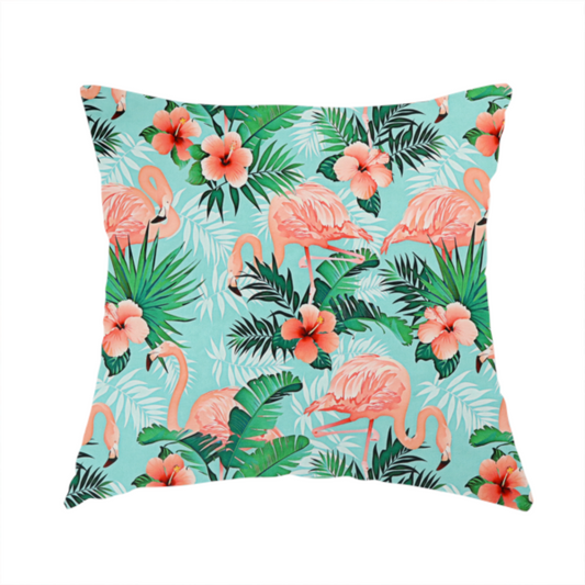 The fabric used to create these handmade cushions is a vibrant tropical pattern featuring pink flamingos, orange hibiscus flowers, and lush green palm leaves on a bright turquoise background.
