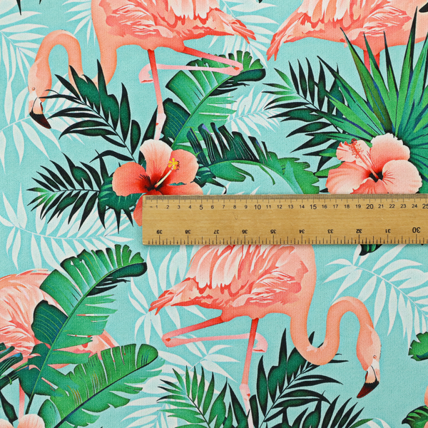 A vibrant tropical pattern featuring pink flamingos, orange hibiscus flowers, and lush green palm leaves on a bright turquoise background.