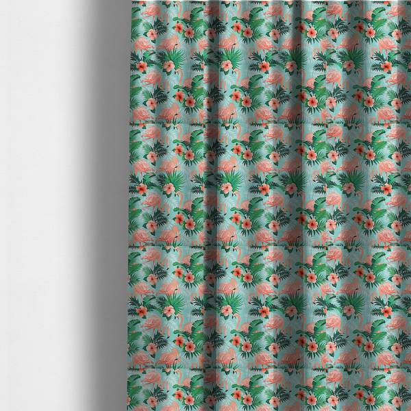 The fabric used to create these made-to-measure curtains is a vibrant tropical pattern featuring pink flamingos, orange hibiscus flowers, and lush green palm leaves on a bright turquoise background.