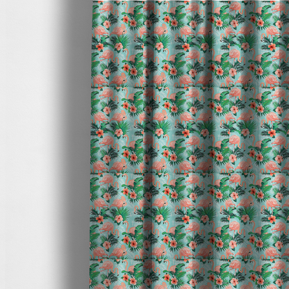The fabric used to create these made-to-measure curtains is a vibrant tropical pattern featuring pink flamingos, orange hibiscus flowers, and lush green palm leaves on a bright turquoise background.