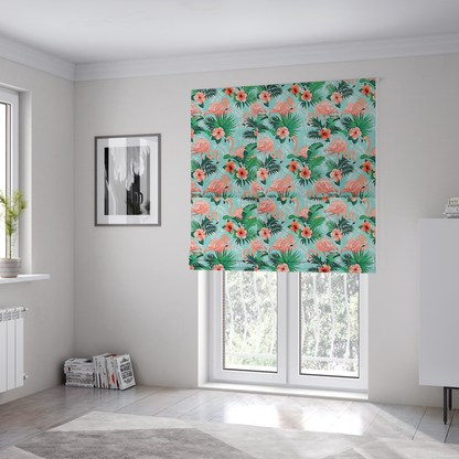 The fabric used to create these Roman blinds is a vibrant tropical pattern featuring pink flamingos, orange hibiscus flowers, and lush green palm leaves on a bright turquoise background.