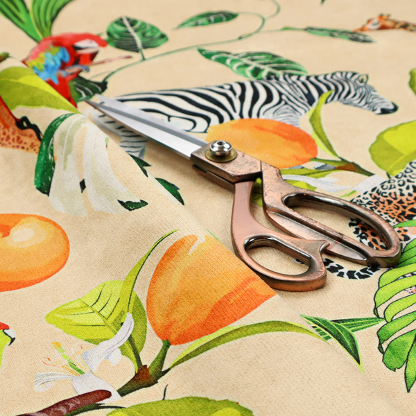 A playful jungle pattern featuring zebras, giraffes, leopards, parrots, and citrus fruits among lush green leaves on a cream-colored background.