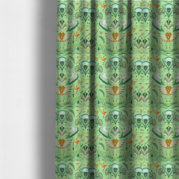 The fabric used to create these made-to-measure curtains is an ornate upholstery fabric with a mirrored botanical and wildlife design. Features white herons with outspread wings, crocodiles, hummingbirds, and butterflies surrounding stylized teal and gold fan motifs on a soft lime-green base.