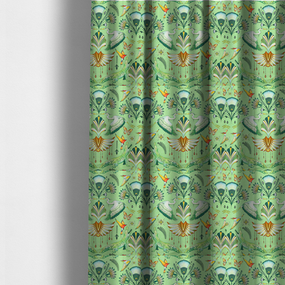 The fabric used to create these made-to-measure curtains is an ornate upholstery fabric with a mirrored botanical and wildlife design. Features white herons with outspread wings, crocodiles, hummingbirds, and butterflies surrounding stylized teal and gold fan motifs on a soft lime-green base.