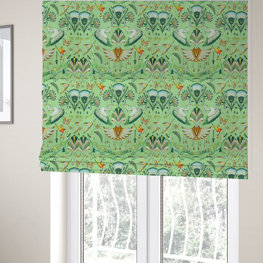 The fabric used to create these Roman blinds is an ornate upholstery fabric with a mirrored botanical and wildlife design. Features white herons with outspread wings, crocodiles, hummingbirds, and butterflies surrounding stylized teal and gold fan motifs on a soft lime-green base.